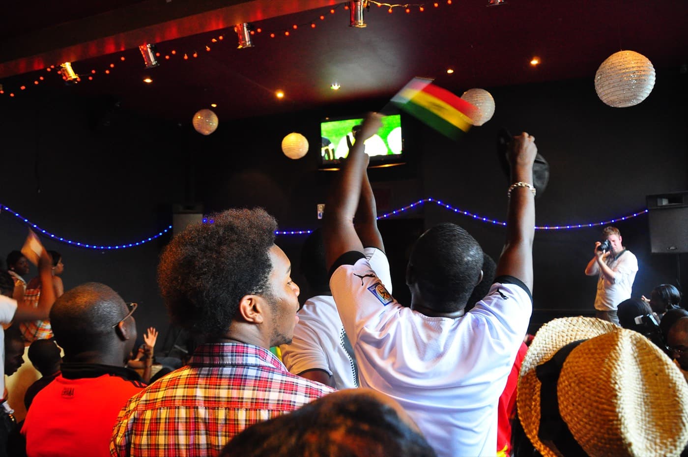 Football fans watching a match at a fan zone